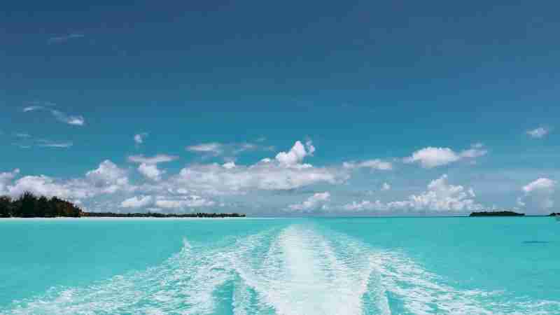 Crystal-clear waters and vibrant skies in Vaitāpē create a tranquil tropical scene., tags: de - pexel